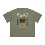 Back of Gray Green enzyme-washed T-shirt with a large Distrito Capital 90 poster graphic