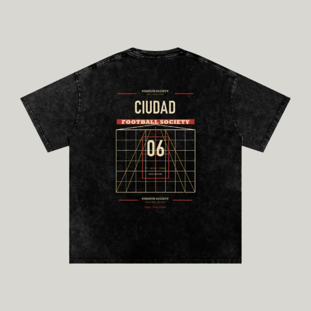 Back of black washed oversized T-shirt with a large Ciudad Football Society grid graphic