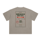 Back of Khaki enzyme-washed T-shirt with a large Mexico Away Days travel graphic