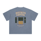 Back of Gray Blue enzyme-washed T-shirt with a large Distrito Capital 90 poster graphic